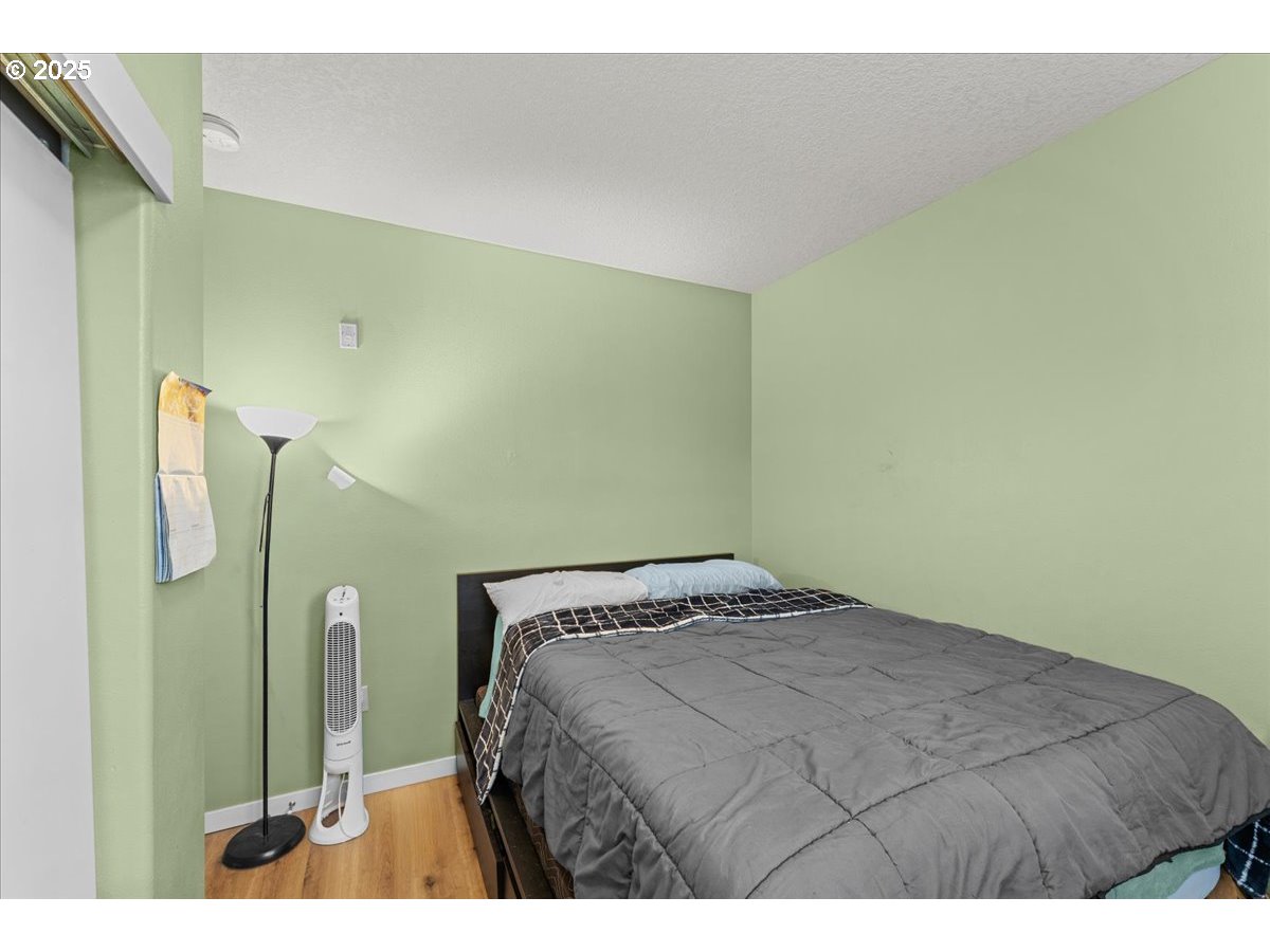 400 Northeast 100th Avenue, Unit 101 Portland, OR 97220 - Photo 21 of 22 a bedroom with a bed and a mirror