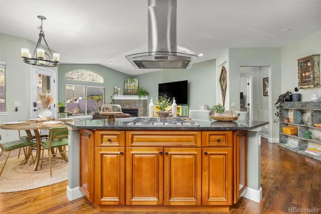 a kitchen with center island dining table and chairs