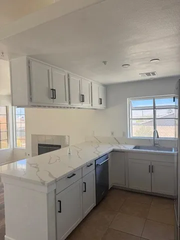 a kitchen with a sink and cabinets