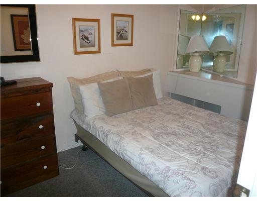 3938 Surfside Boulevard, Unit 3332 Corpus Christi, TX 78402 - Photo 4 of 8 a bedroom with a bed and a mirror on dresser