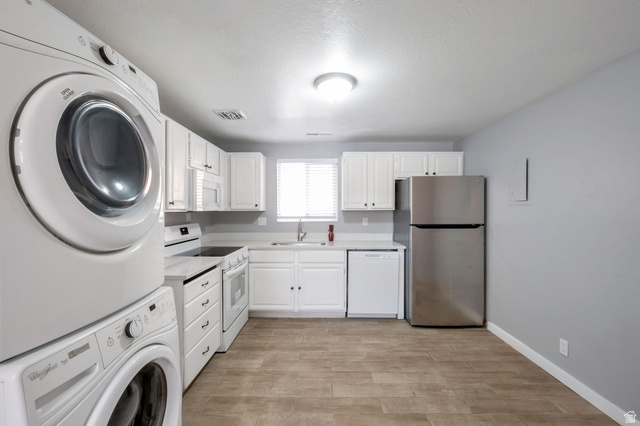 434 South 700 West, Unit 2 Provo, UT 84601 - Photo 6 of 15 White kitchen cabinetry with integrated white appliances and stainless steel refrigerator