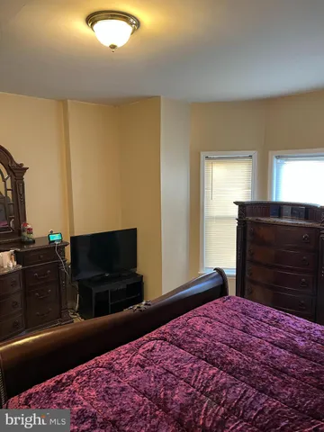 a bedroom with a bed and flat screen tv