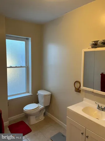 a bathroom with a toilet a sink and a mirror
