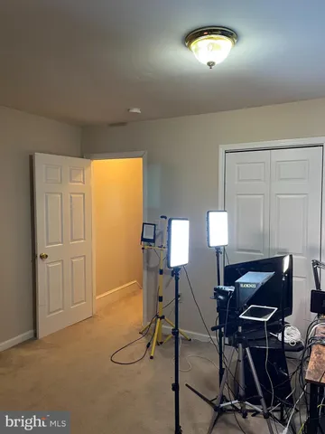 a view of a workspace with furniture and a window