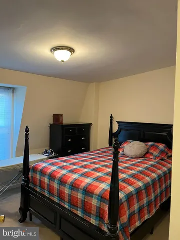 a bedroom with a bed and dresser