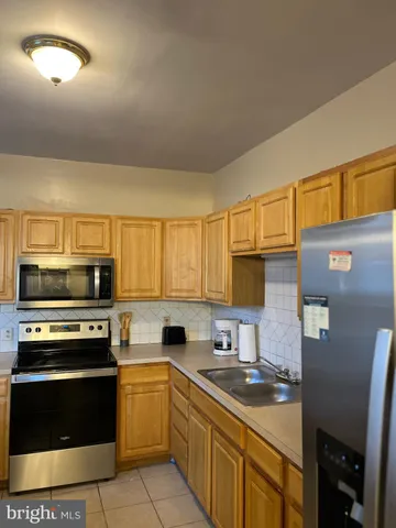 a kitchen with stainless steel appliances a stove sink and microwave