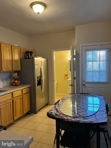 a kitchen with stainless steel appliances granite countertop a sink refrigerator and microwave