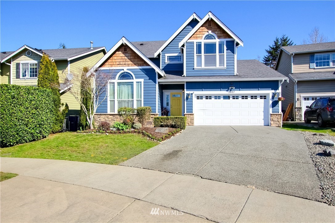 3827 160th Place Southeast Bothell, WA 98012 - Photo 2 of 40 a front view of a house with a yard and garage