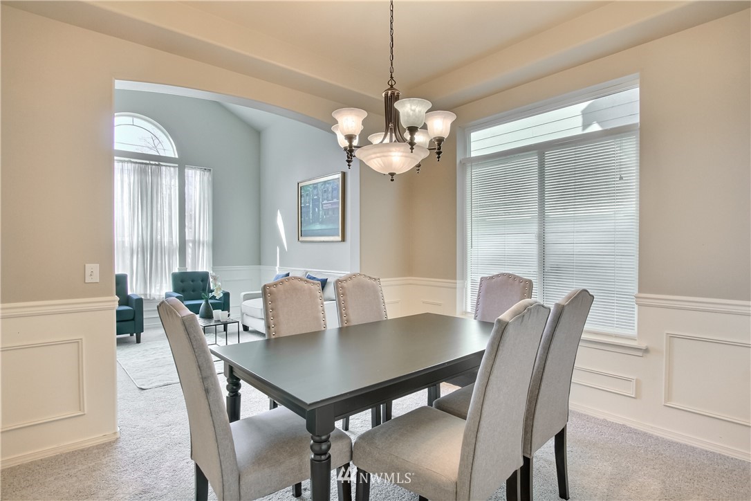 3827 160th Place Southeast Bothell, WA 98012 - Photo 11 of 40 a view of a dining room with furniture window and wooden floor