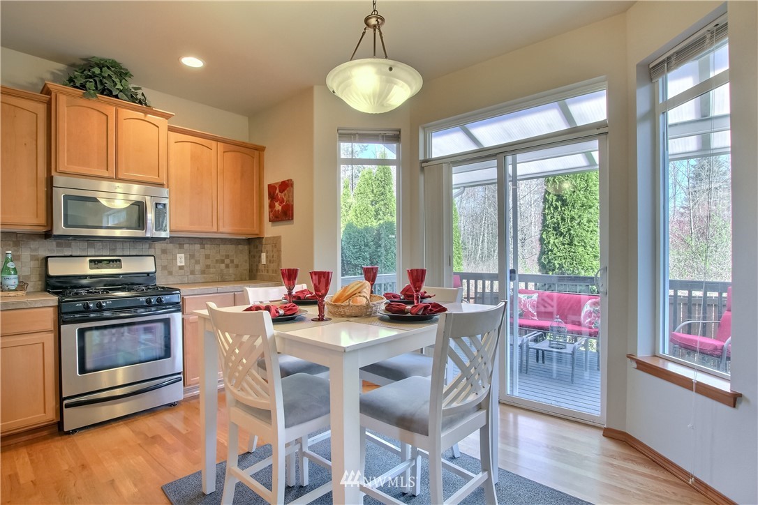 3827 160th Place Southeast Bothell, WA 98012 - Photo 17 of 40 a kitchen with stainless steel appliances a stove a sink and a microwave