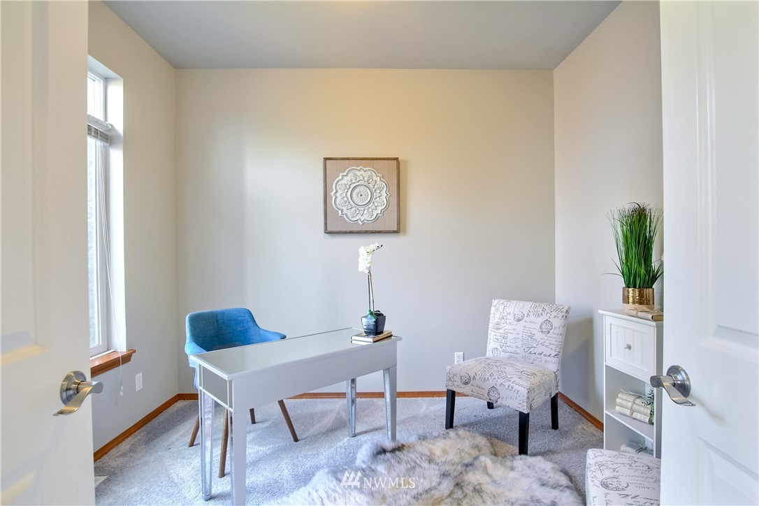3827 160th Place Southeast Bothell, WA 98012 - Photo 18 of 40 a view of a workspace with furniture and a window