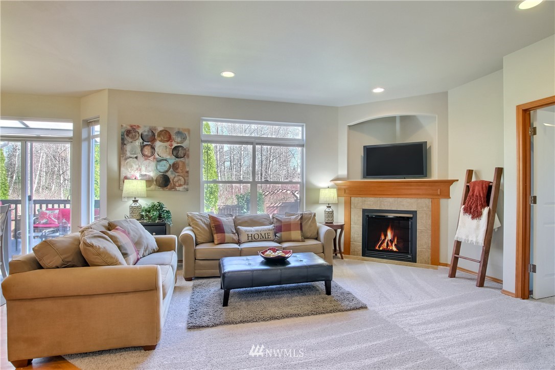 3827 160th Place Southeast Bothell, WA 98012 - Photo 19 of 40 a living room with furniture and a fireplace