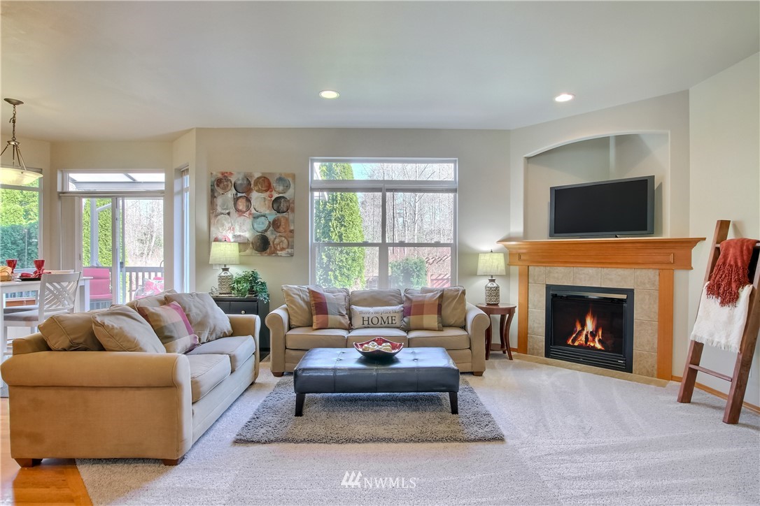 3827 160th Place Southeast Bothell, WA 98012 - Photo 20 of 40 a living room with furniture and a fireplace