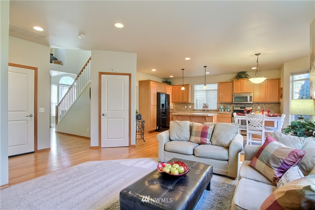 3827 160th Place Southeast Bothell, WA 98012 - Photo 22 of 40 a living room with furniture kitchen view and a wooden floor