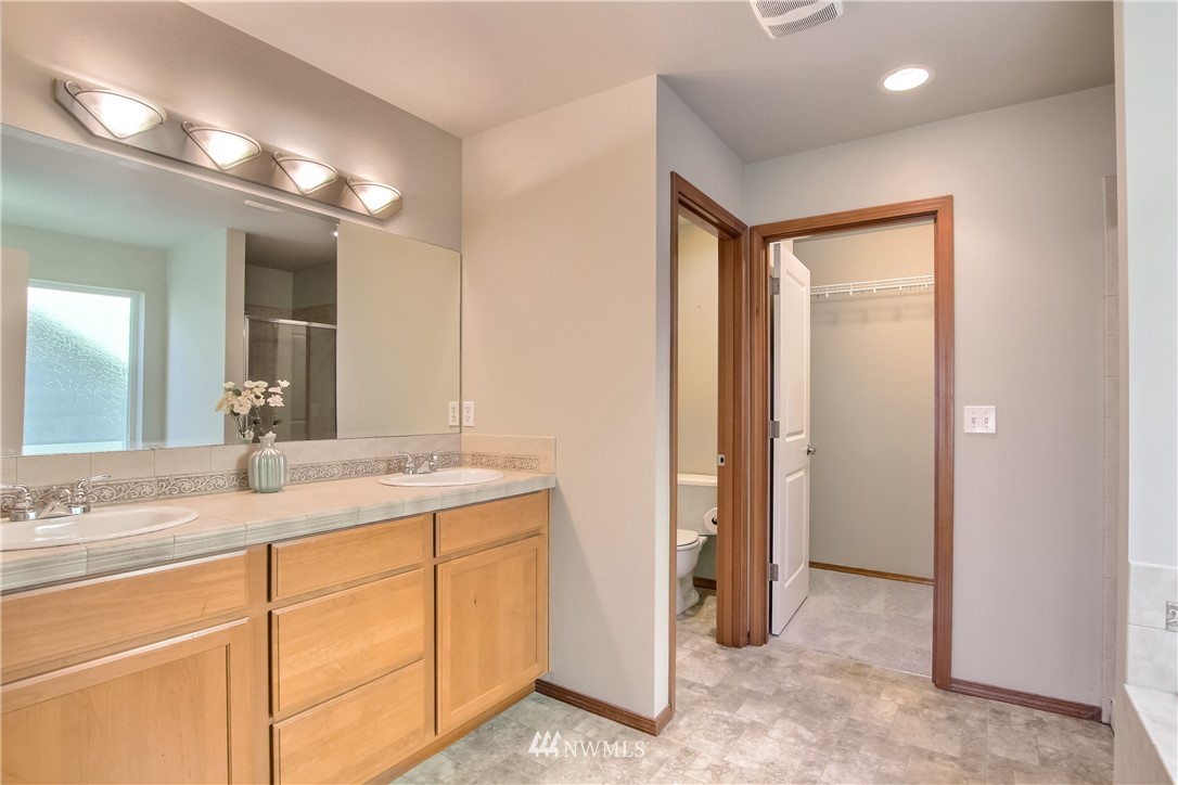 3827 160th Place Southeast Bothell, WA 98012 - Photo 26 of 40 a bathroom with a sink and a mirror