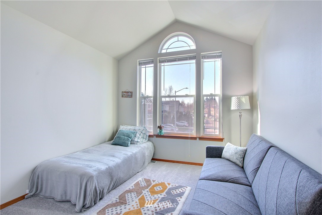 3827 160th Place Southeast Bothell, WA 98012 - Photo 31 of 40 a bedroom with a bed and a couch next to a window