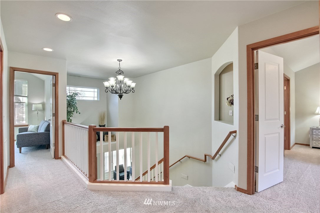 3827 160th Place Southeast Bothell, WA 98012 - Photo 33 of 40 a view of hallway with furniture and a chandelier
