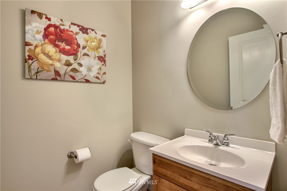 3827 160th Place Southeast Bothell, WA 98012 - Photo 35 of 40 a bathroom with a sink and mirror with toilet
