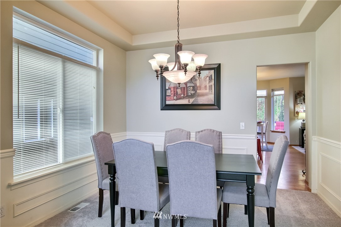 3827 160th Place Southeast Bothell, WA 98012 - Photo 10 of 40 a view of a dining room with furniture window and wooden floor