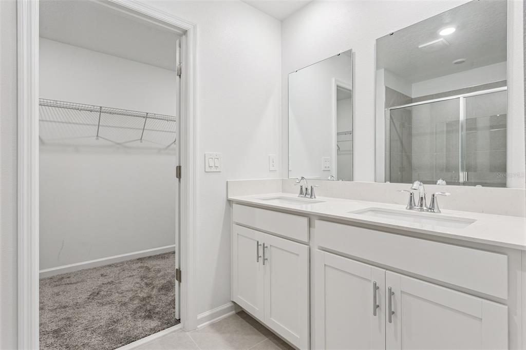 2916 Transformation Way Clermont, FL 34714 - Photo 17 of 91 a bathroom with a double vanity sink and mirror