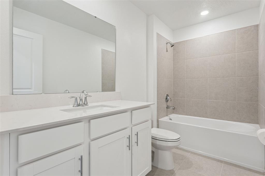 2916 Transformation Way Clermont, FL 34714 - Photo 23 of 91 a bathroom with a granite countertop sink a toilet and a bathtub