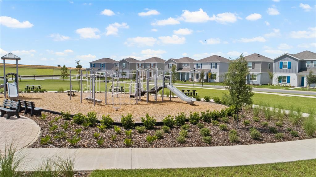 2916 Transformation Way Clermont, FL 34714 - Photo 29 of 91 a view of a lake with a house in the background