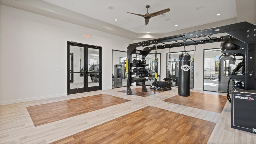 2916 Transformation Way Clermont, FL 34714 - Photo 59 of 91 a view of a livingroom with hardwood floor and a ceiling fan