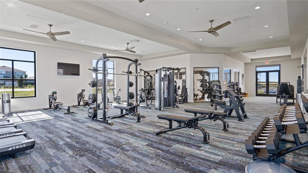 2916 Transformation Way Clermont, FL 34714 - Photo 65 of 91 a view of a room with lots of wooden furniture and windows