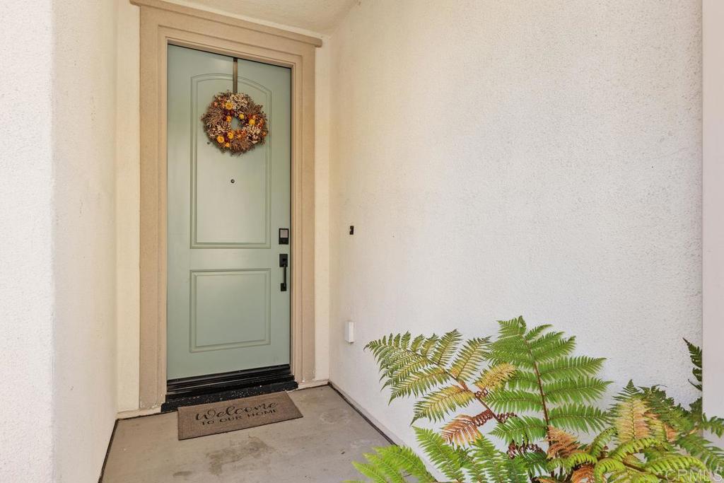 655 Merit Drive San Marcos, CA 92078 - Photo 2 of 35 a view of a hallway with wooden floor
