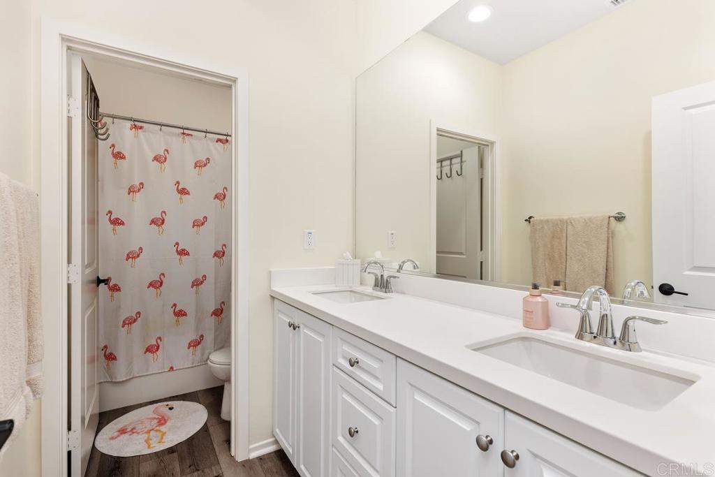 655 Merit Drive San Marcos, CA 92078 - Photo 22 of 35 a bathroom with a sink a toilet and a mirror