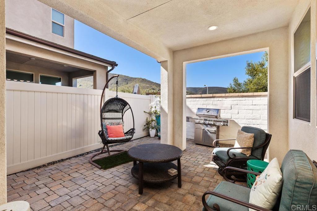 655 Merit Drive San Marcos, CA 92078 - Photo 24 of 35 a living room with furniture a rug and white walls