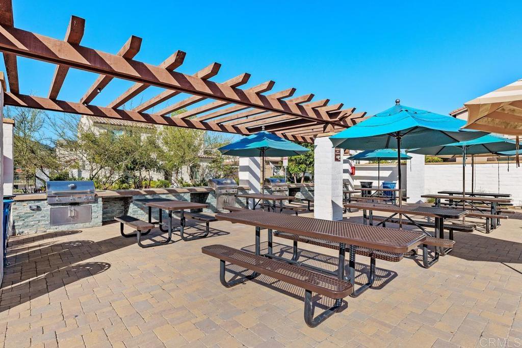655 Merit Drive San Marcos, CA 92078 - Photo 30 of 35 a view of a swimming pool with a table and chairs under an umbrella