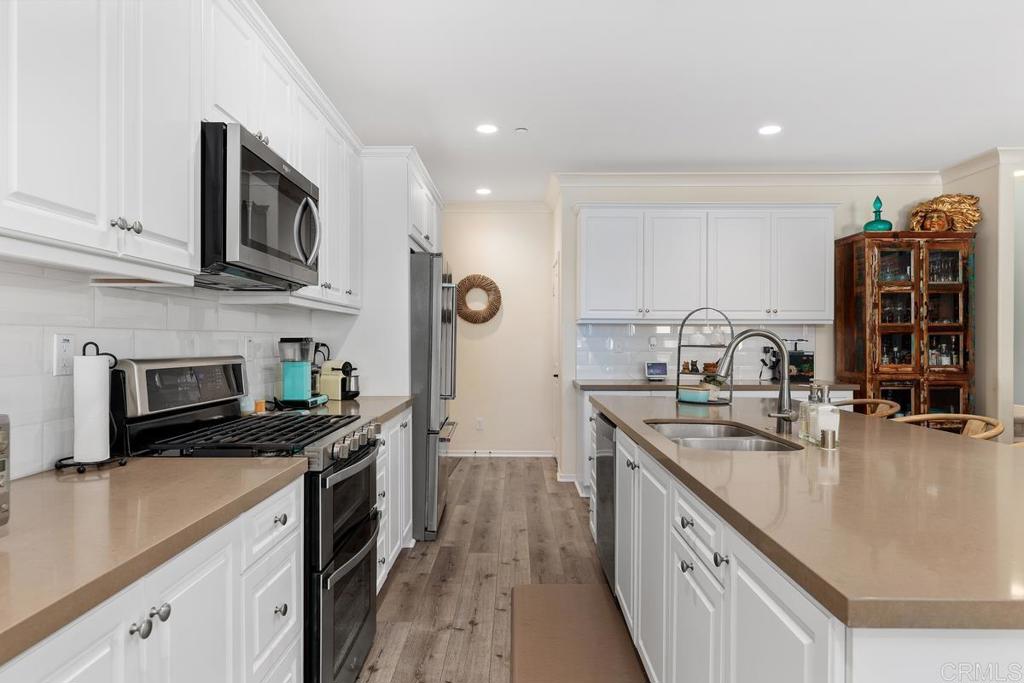 655 Merit Drive San Marcos, CA 92078 - Photo 8 of 35 a kitchen with stainless steel appliances granite countertop a sink stove and refrigerator