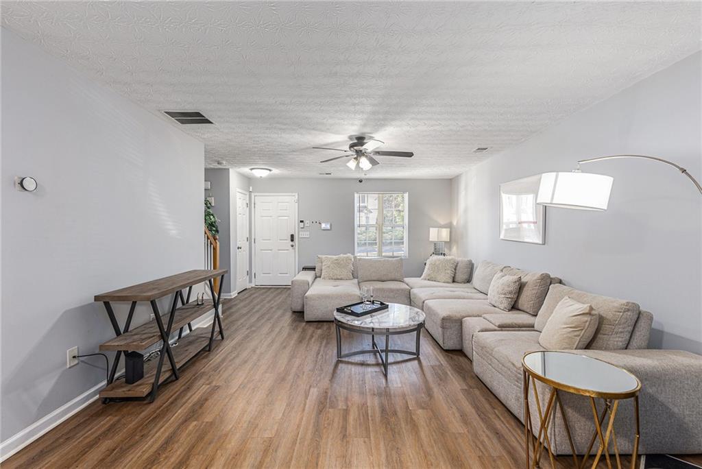 6536 Arbor Gate Drive Southwest, Unit 2 Mableton, GA 30126 - Photo 6 of 27 a living room with furniture and a wooden floor