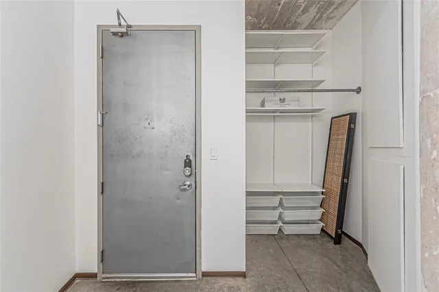 a view of walk in closet with empty racks