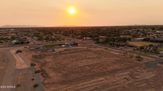 an aerial view of house with yard and mountain view in back