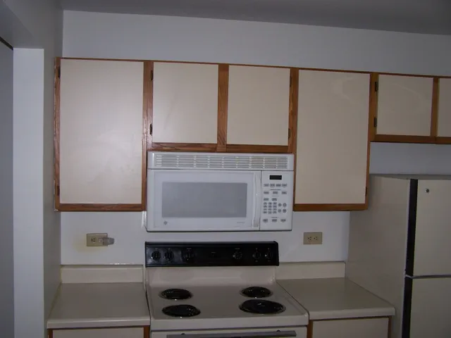 a kitchen with a stove and a microwave