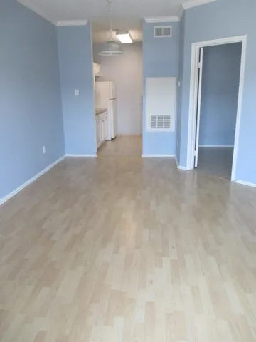 a kitchen with a sink cabinets and a refrigerator