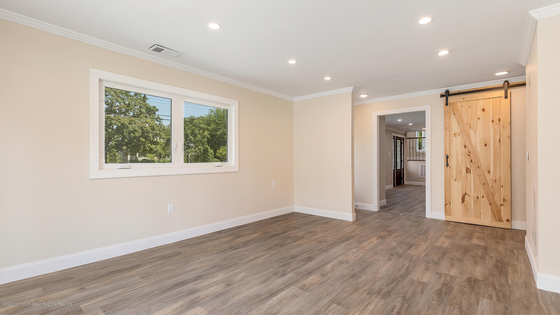 138 Cherry Tree Farm Road Middletown, NJ 07748 - Photo 21 of 47 a view of an empty room with wooden floor and a window