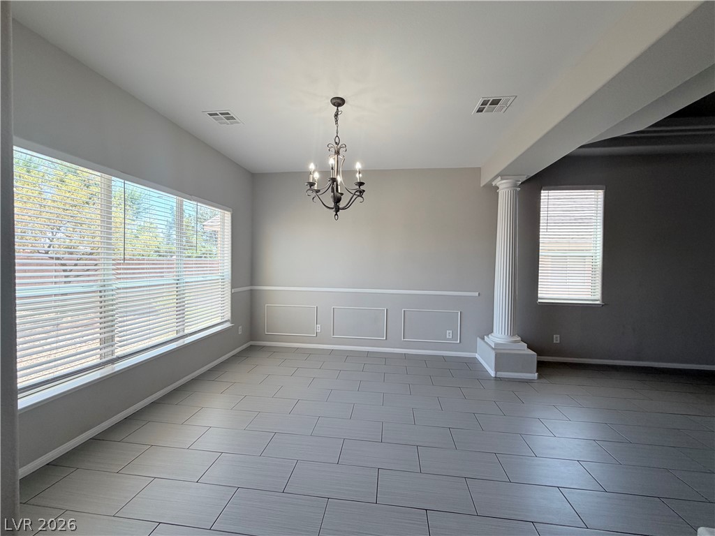 6116 Rabbit Track Street Las Vegas, NV 89130 - Photo 21 of 28 A classic chandelier illuminates this spacious room featuring elegant chair rail molding and tile flooring.