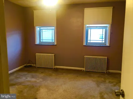 a view of an empty room with windows