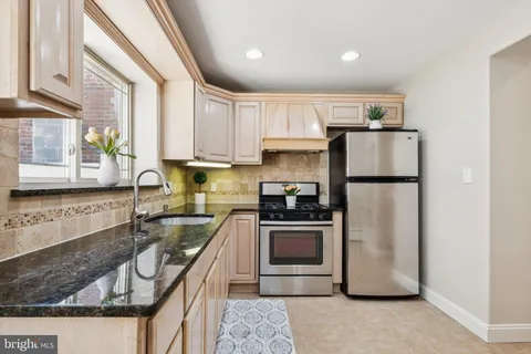 a kitchen with a refrigerator a sink and cabinets