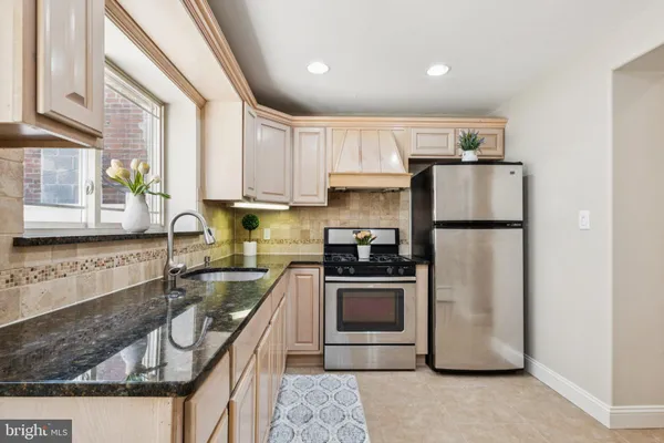 a kitchen with a refrigerator a sink and cabinets