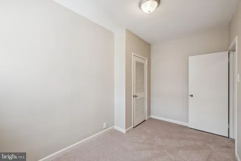 a bedroom with bed and windows
