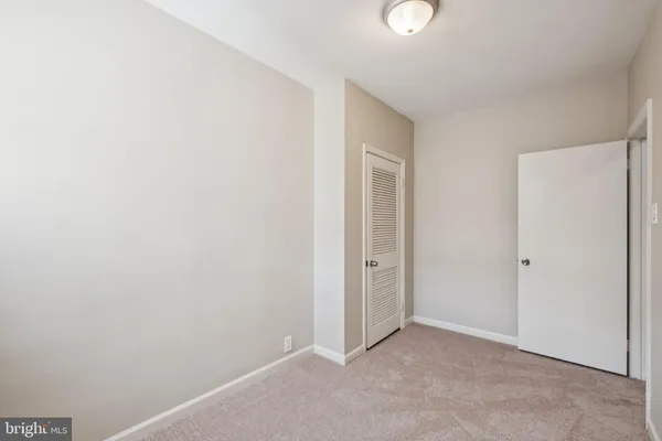a bedroom with bed and windows