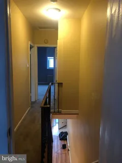 a view of a hallway with staircase
