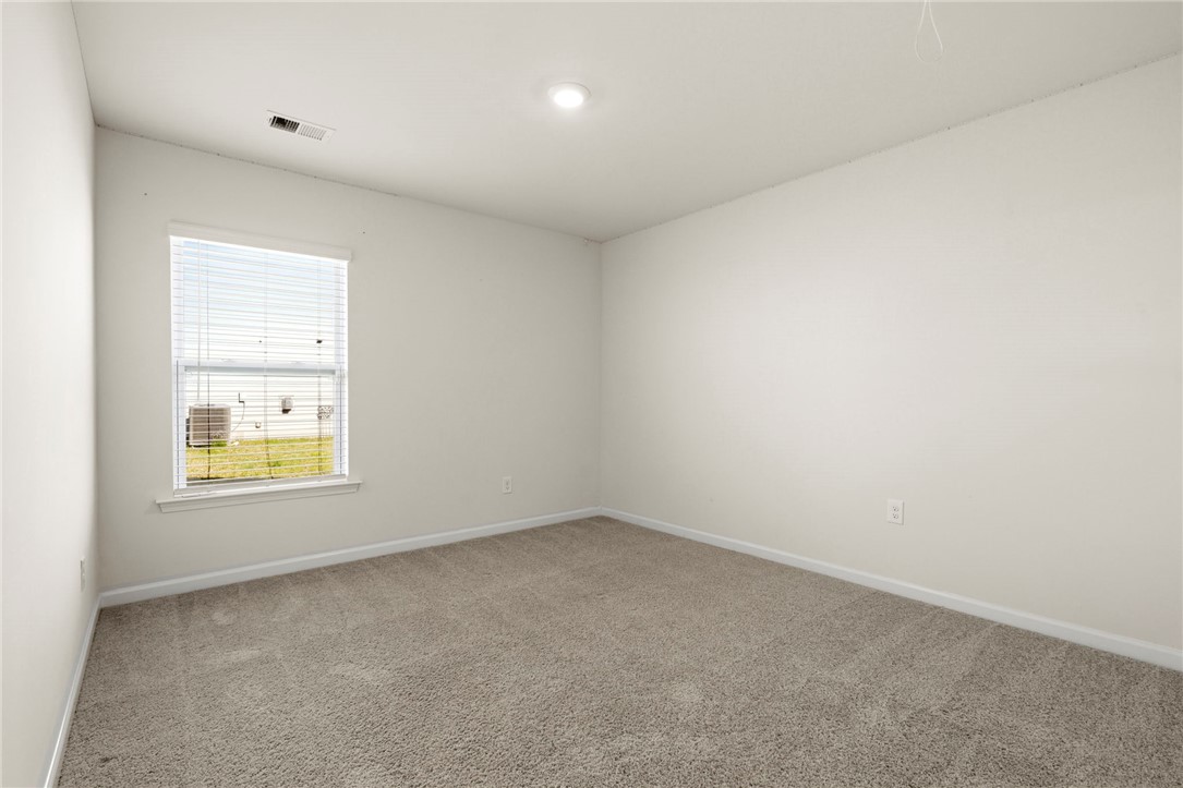 205 Hillendale Way Pelzer, SC 29669 - Photo 20 of 29 This bright bedroom offers a neutral canvas, ready for your personal touch.