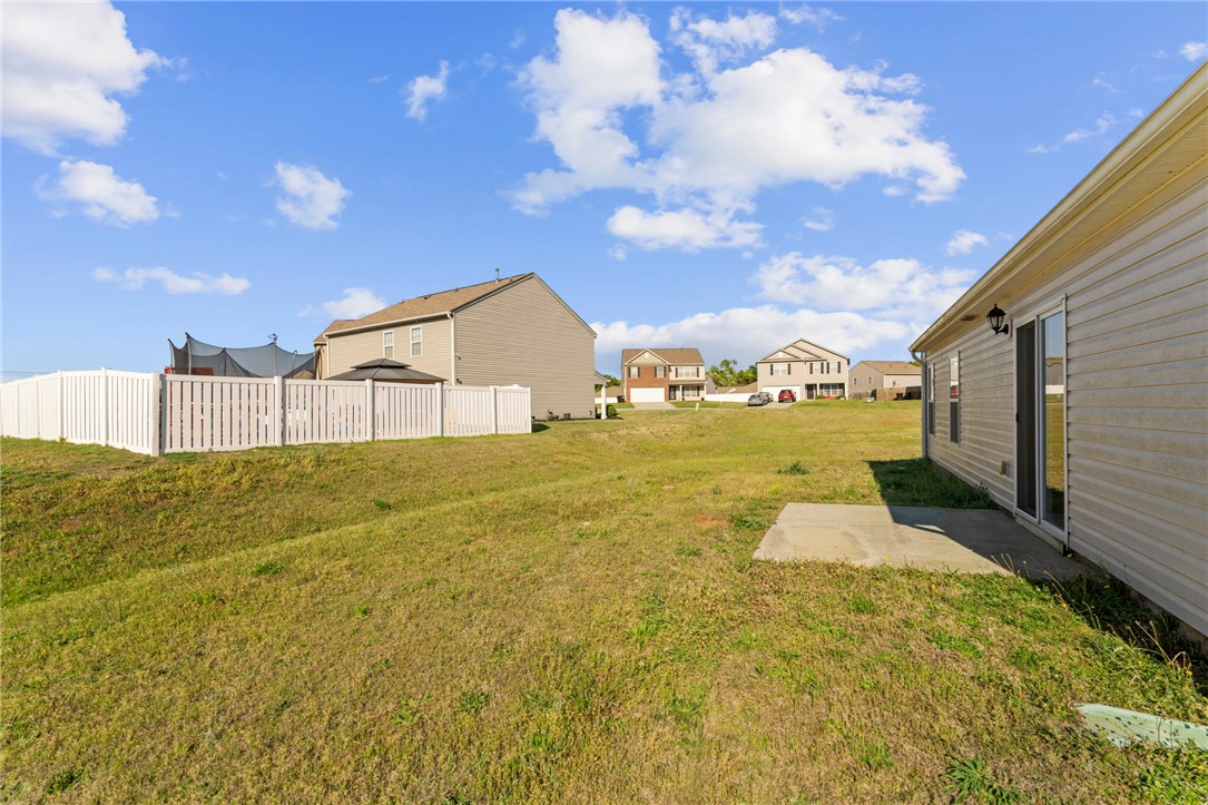 205 Hillendale Way Pelzer, SC 29669 - Photo 22 of 29 This spacious yard offers ample outdoor living potential, complete with a private patio and fencing.