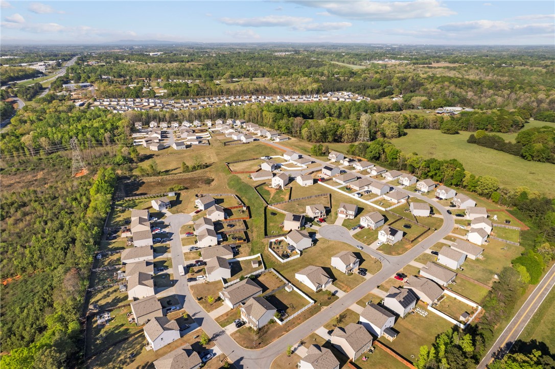 205 Hillendale Way Pelzer, SC 29669 - Photo 25 of 29 An aerial perspective reveals a vibrant community nestled among verdant landscapes, offering a peaceful residential setting.
