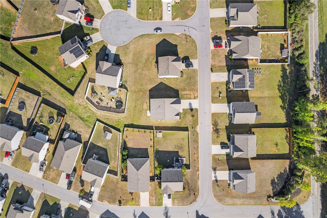 205 Hillendale Way Pelzer, SC 29669 - Photo 27 of 29 An aerial view of a vibrant residential neighborhood with houses, streets, and green spaces.